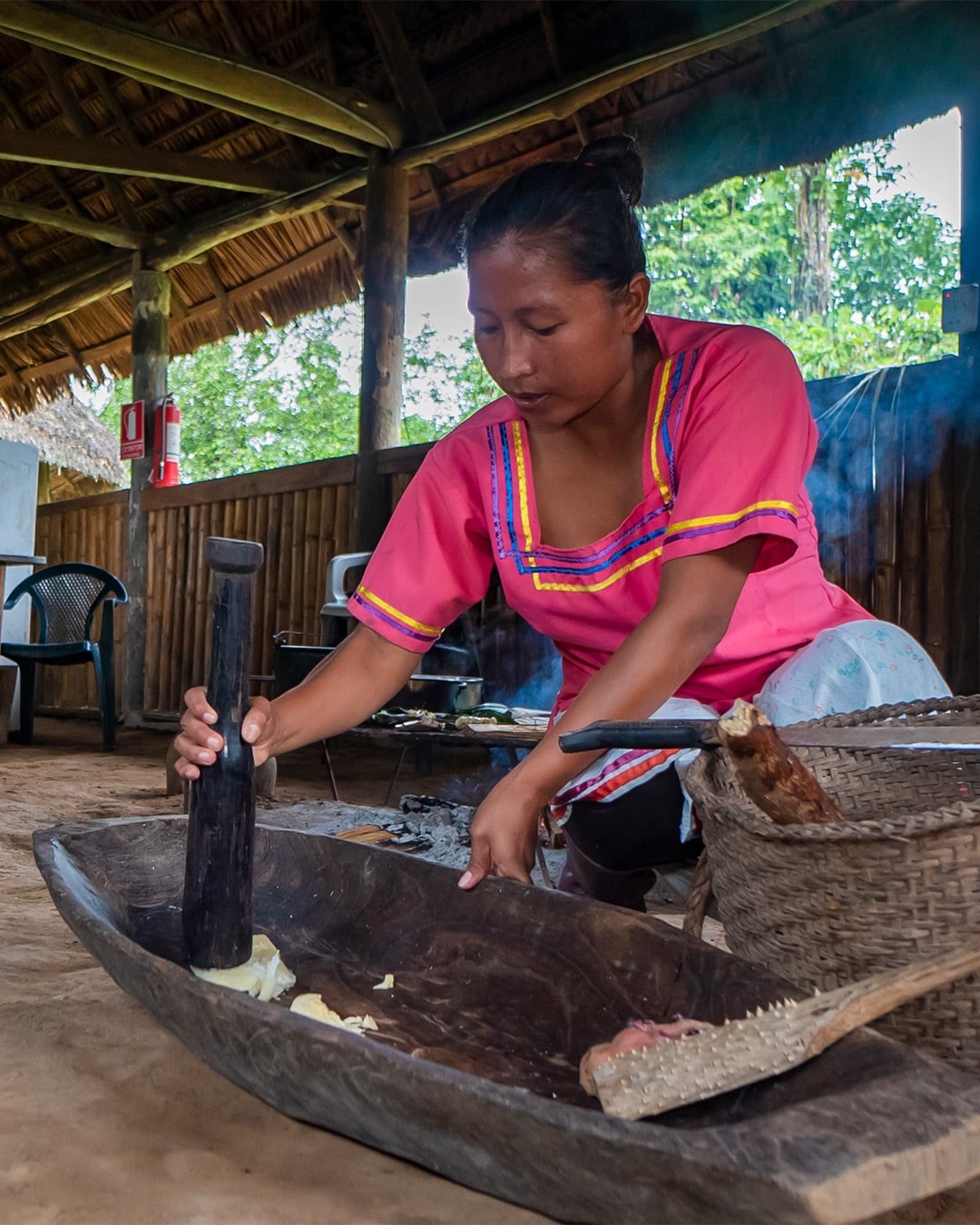 Woman preparing food in traditional setting - La Selva Eco Lodge