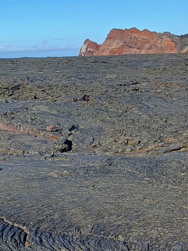 Rugged volcanic terrain with distant cliffs - volcanic terrain - Galapagos Islands in a Glimpse - Golden Galapagos Cruises