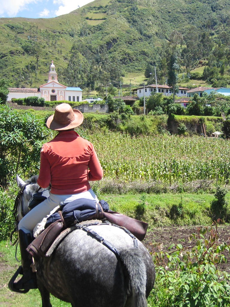 Person horseback riding in scenic landscape - Horseback Ride - Golden Galapagos Cruises