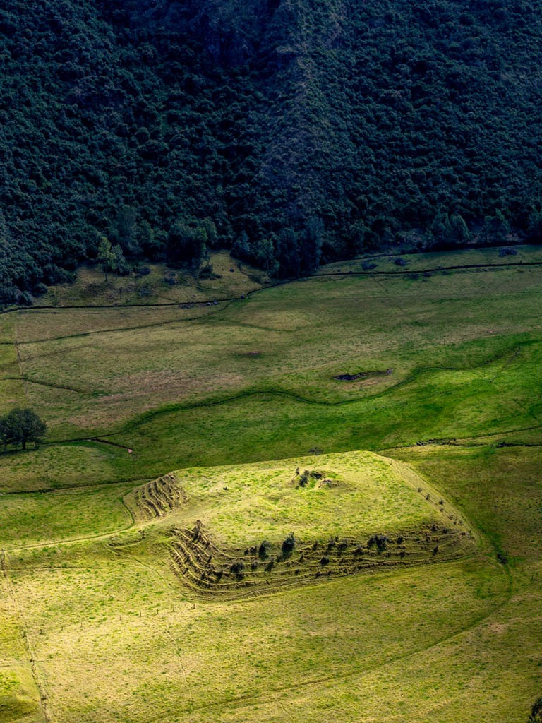 Ancient pyramid in lush green landscape - Caraqui Pyramids - Golden Galapagos Cruises